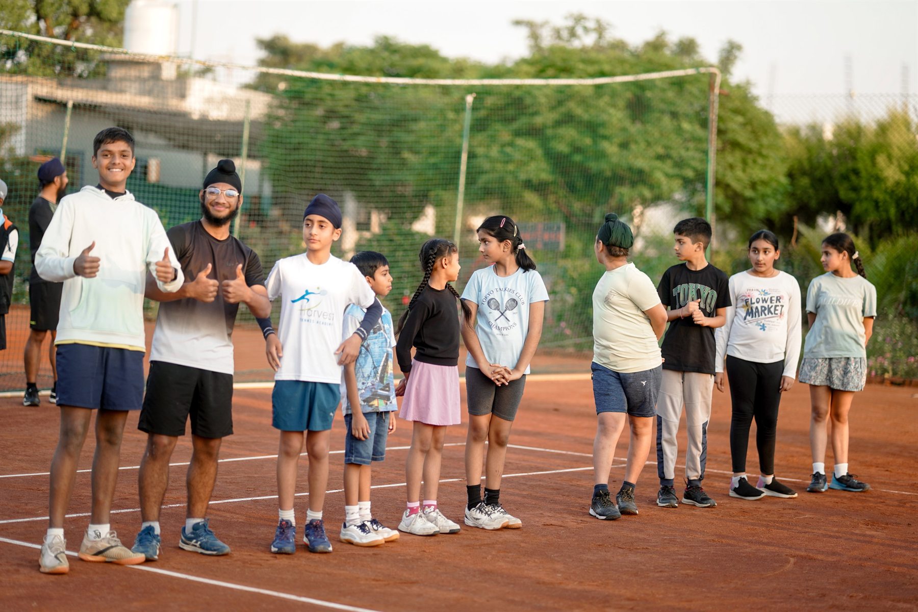 Junior tennis players standing together on court